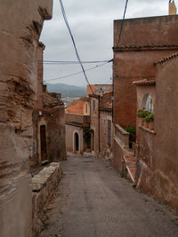 Street amidst buildings against sky in city