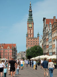 Group of people in front of buildings in city