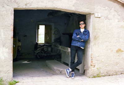 Side view of man standing in abandoned house