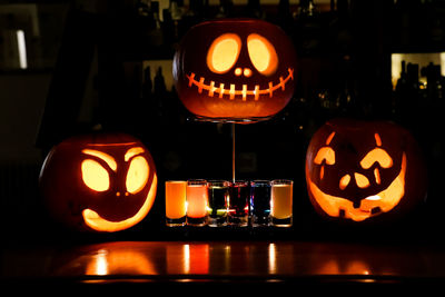 Illuminated pumpkin on table