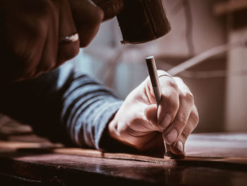 Midsection of man working on table