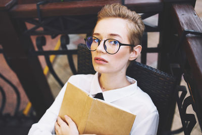 Portrait of young woman sitting on seat