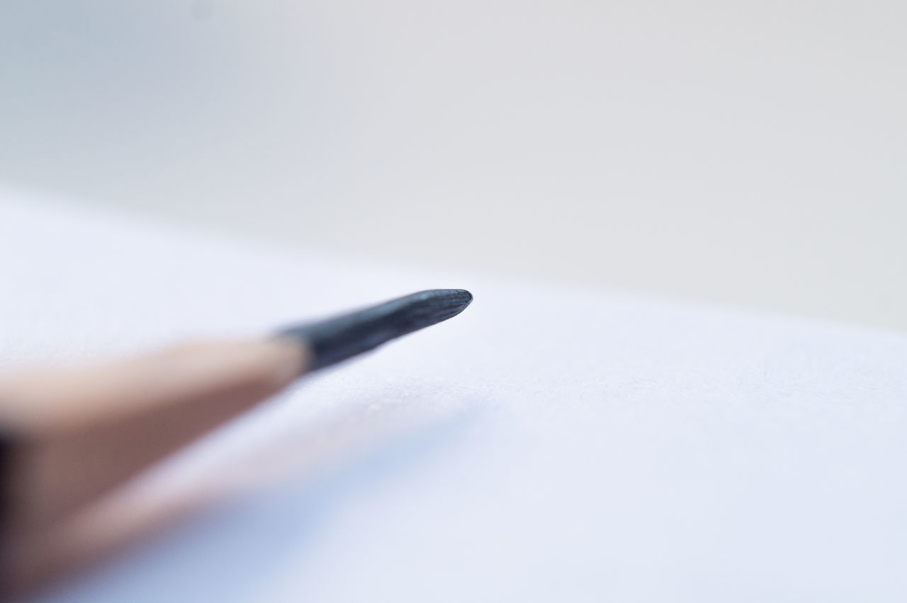 CLOSE-UP OF PENCILS ON TABLE