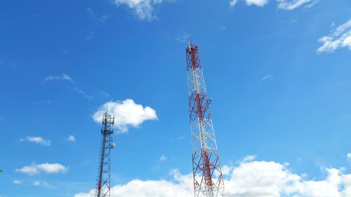 Low angle view of communications tower against blue sky