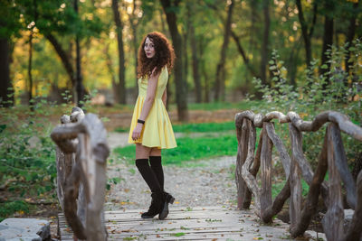 Portrait of young woman standing in forest