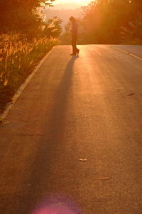 Rear view of a person standing on road