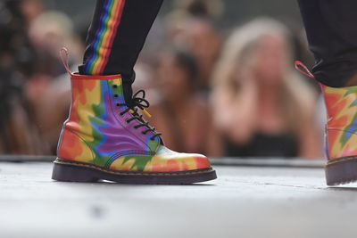 Low section of person wearing colorful shoes on stage