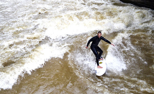 High angle view of man surfing in sea