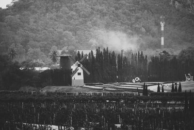 Built structure by trees against sky