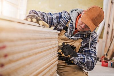 Man working on wood at workshop