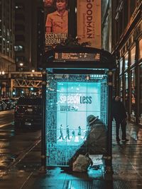 Woman in illuminated city at night