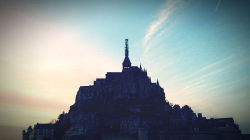 Low angle view of building against sky at sunset