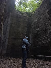 Rear view of man standing on rock