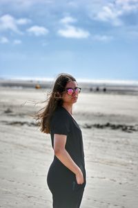 Young woman standing at beach