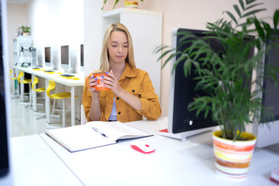 Young woman using laptop at table