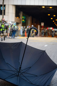 Close-up of wet umbrella on street in rainy season