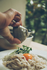 Cropped hand of person preparing food