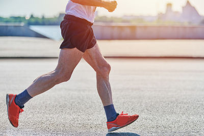 Running old man. old man jogging in sportswear on city road. healthy lifestyle, fitness sport hobby