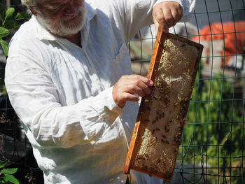 Midsection of man working at farm