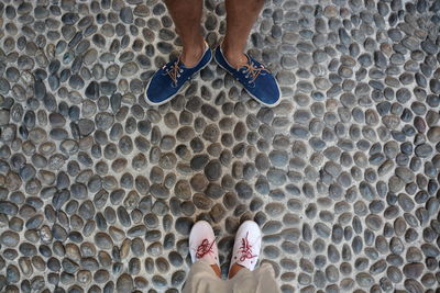 Low section of man standing on tiled floor