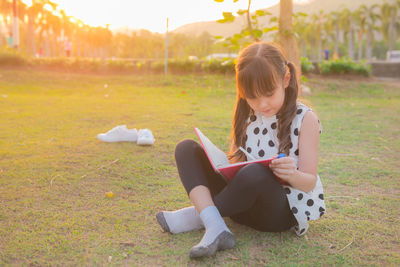 Girl studying on field