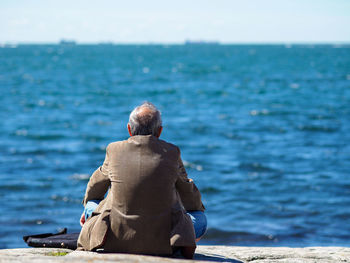 Rear view of man standing on beach