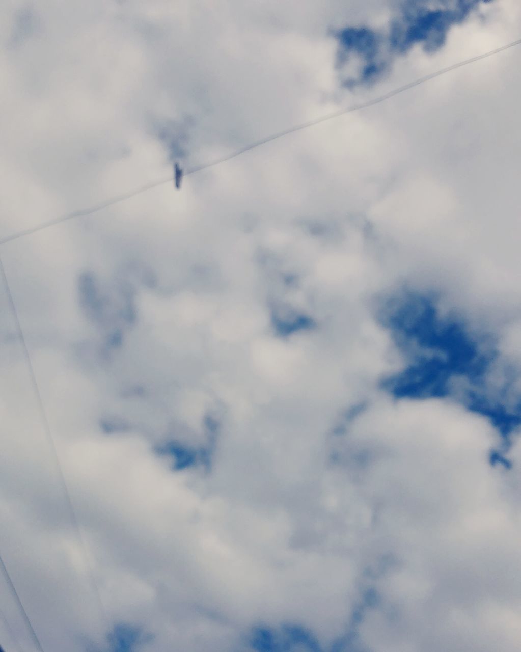 sky, low angle view, cloud - sky, power line, cable, cloudy, cloud, electricity, connection, nature, power supply, tranquility, day, beauty in nature, outdoors, no people, scenics, transportation, electricity pylon, cloudscape