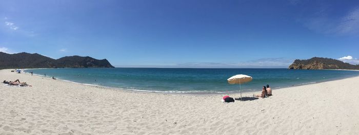 Scenic view of beach against blue sky