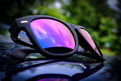Close-up of sunglasses on side-view mirror