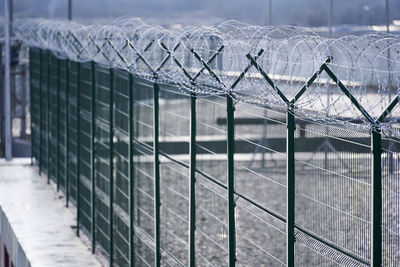 Close-up of metal fence with snow