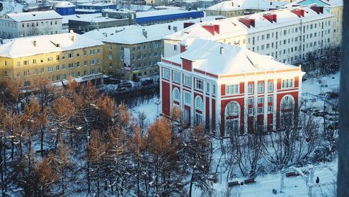 High angle view of snow covered buildings in city