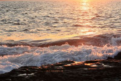 Aerial view of sea against sky at sunset