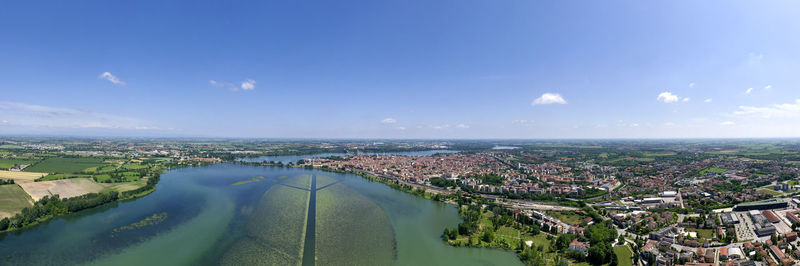 Aerial view of buildings in city against sky