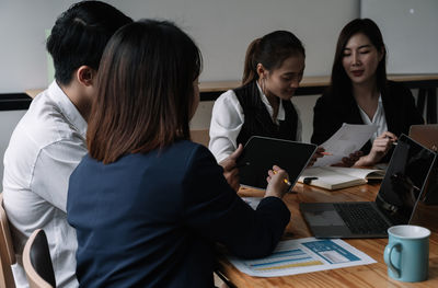 Portrait of smiling business colleagues working at office