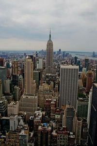 View of cityscape against cloudy sky