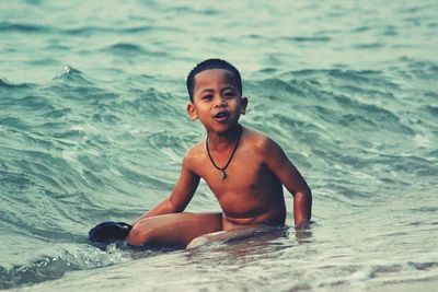 Portrait of boy swimming in sea