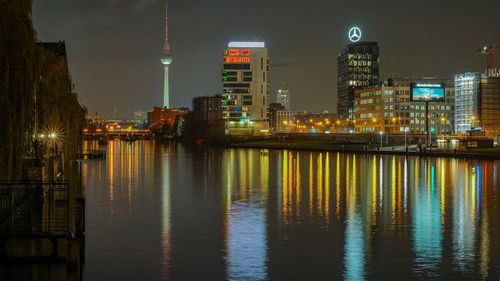 Illuminated city at waterfront