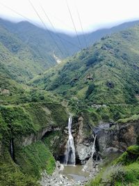 Scenic view of river amidst mountains against sky