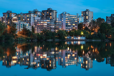 Reflection of illuminated buildings in lake