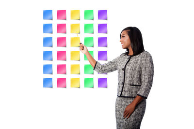 Woman standing with multi colored umbrella