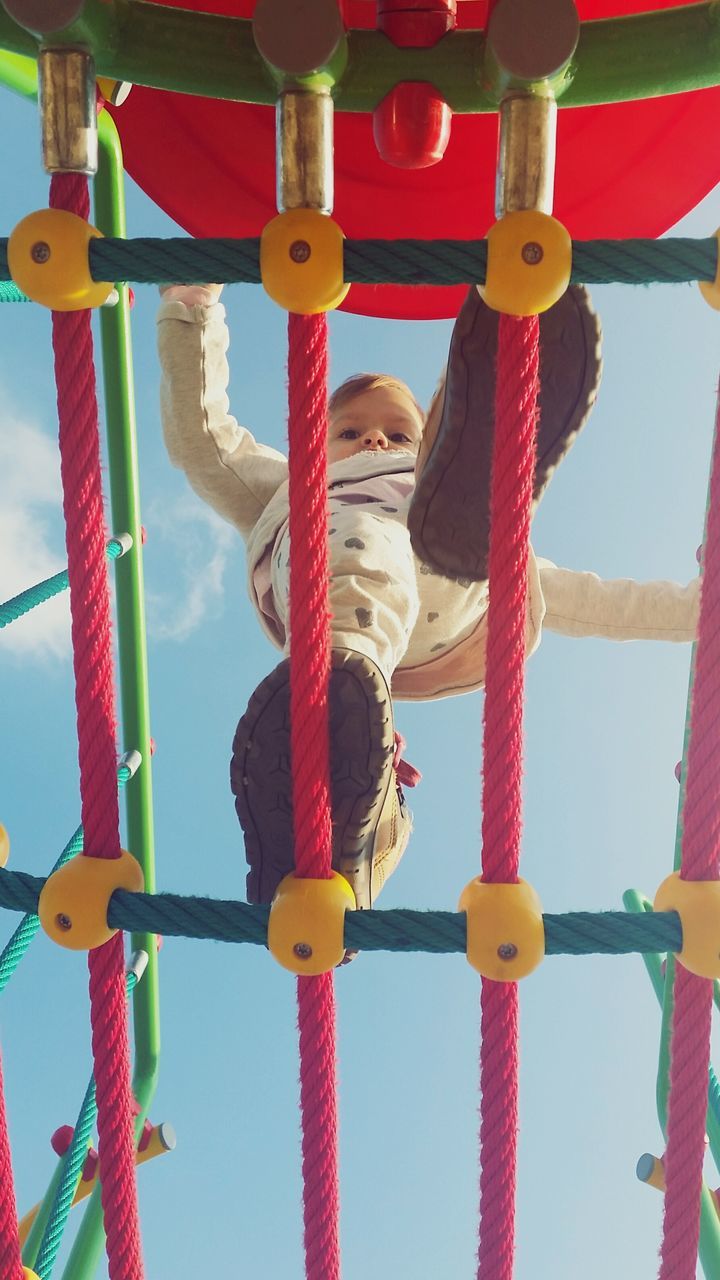 low angle view, childhood, multi colored, metal, blue, hanging, rope, fun, protection, sky, day, amusement park, playground, outdoors, toy, safety, colorful, boys, in a row, red