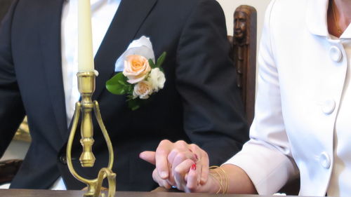 Midsection of man holding bouquet