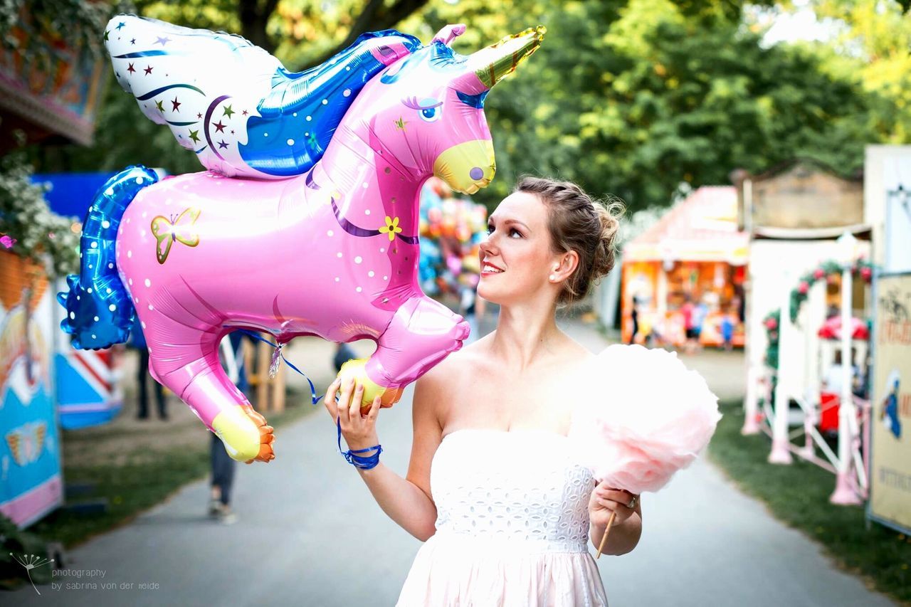 person, lifestyles, childhood, focus on foreground, leisure activity, happiness, holding, casual clothing, elementary age, girls, smiling, front view, portrait, looking at camera, fun, young adult, young women, enjoyment