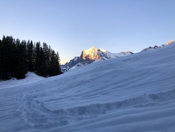 Scenic view of snowcapped mountains against clear sky