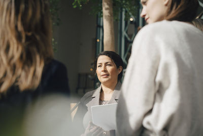 Confident businesswoman with colleagues in conference meeting