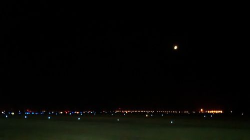 Illuminated lights against sky at night