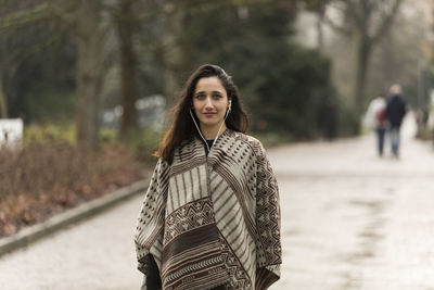 Portrait of smiling young woman standing outdoors