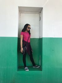 Full length of girl standing at doorway