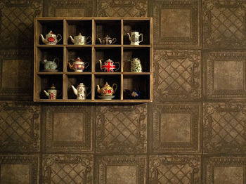 Various teapots in shelves