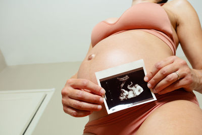 Midsection of woman using mobile phone